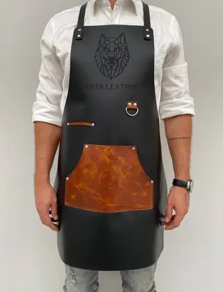 Man wearing a black apron with a tan pocket and an engraved logo