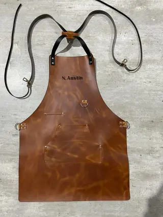 Tan apron engraved S. Austin