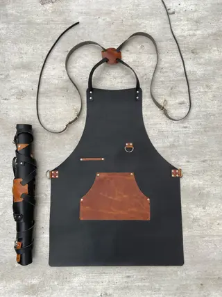 Black apron with a tan pocket