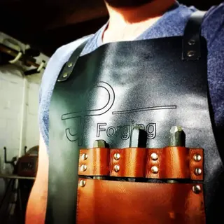 Close-up of the tan chest pocket holding tools