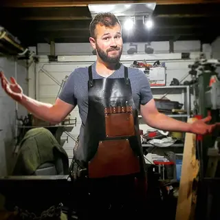 Smith wearing the split-leg apron in his workshop