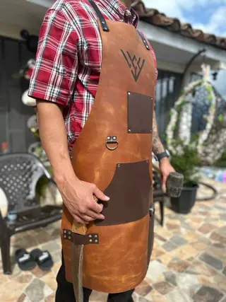 Man wearing a tan woodworking apron with dark brown pockets