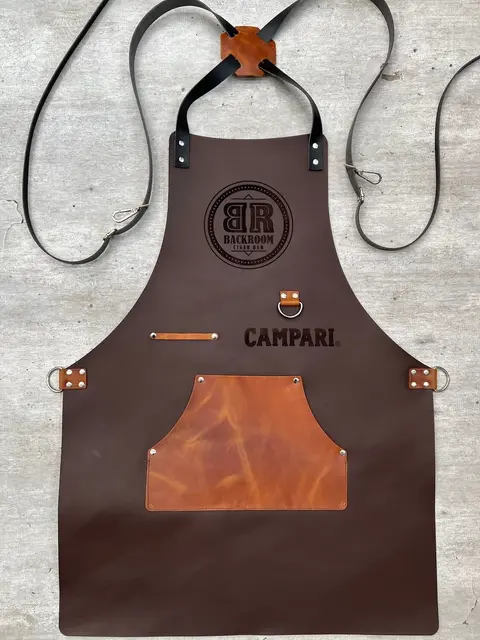 Dark brown leather apron with a company logo and tan pocket