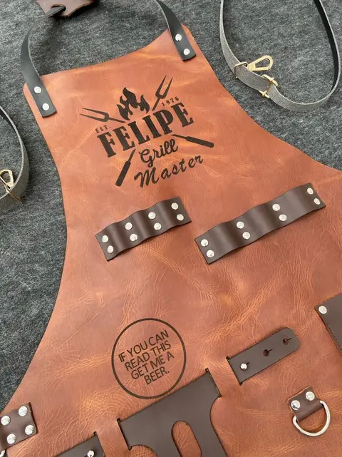 Tan leather apron engraved "Felipe Grill Master"