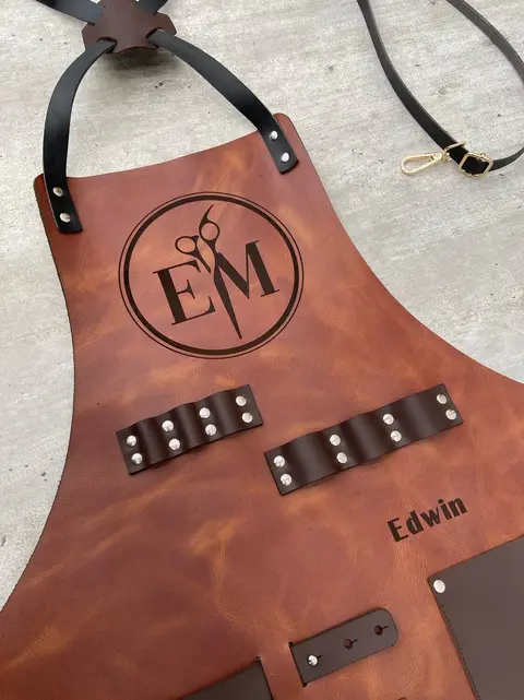 Tan leather apron with an engraved monogram and name